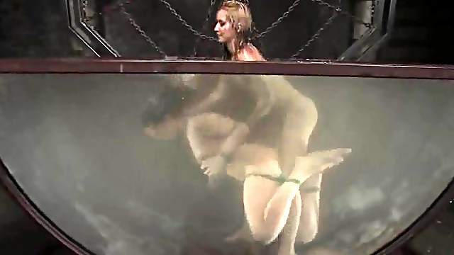 Gorgeous brunette gets toyed by a blonde in water bondage video