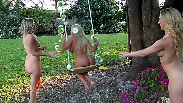 Three blonde cuties lick each other's cunts in the garden