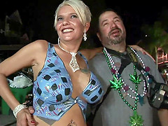 Sexy blondes flash their big tits and shaved pussy in street party