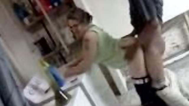 Amateur blond wearing glasses enjoys interracial rear sex in a kitchen