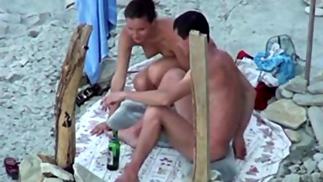 Pretty brunette sucks her man's dick on a beach in hardcore clip