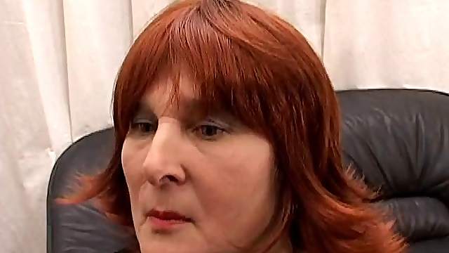 Mature woman with long red hair enjoying a hardcore doggy style fuck