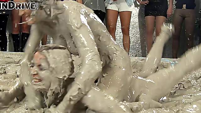 Wild brunette with a slim sexy body having a catfight in a mudbath
