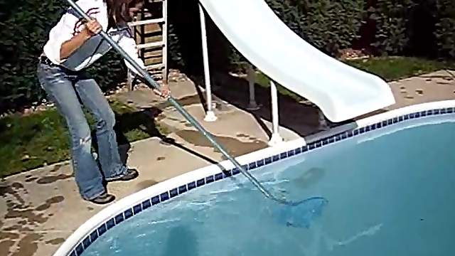 Cute black-haired babe rescuing a frog out of the pool