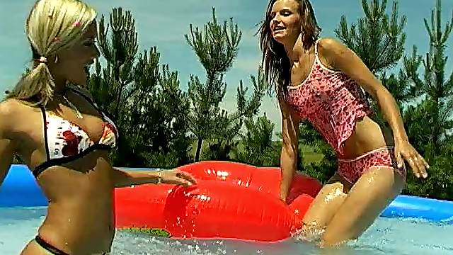 Lesbian cutie has her coochie throbbed with a toy at the pool