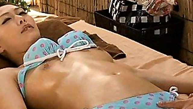 Japanese AV Model wears sexy lingerie as she lays on a bed