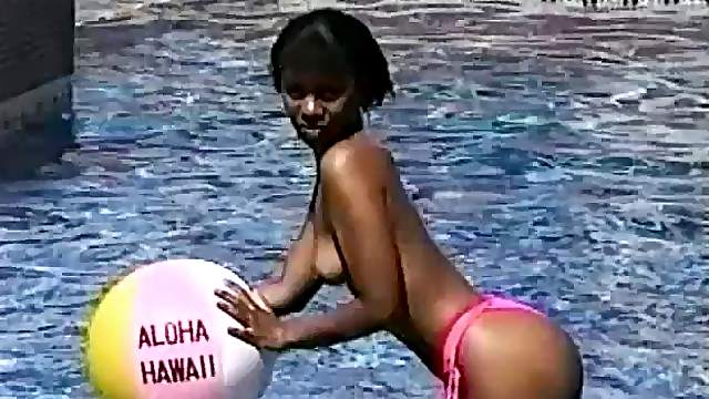 Beautiful Asian girl goes totally naked by the pool and reveals tits