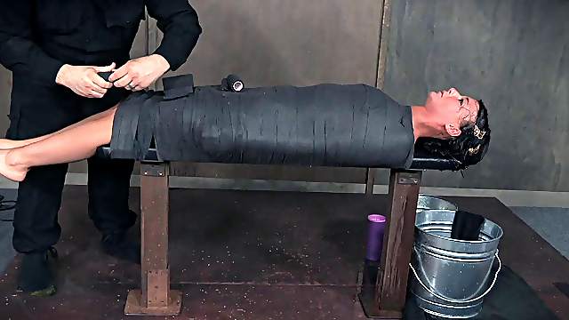 Curvy brunette with natural tits tied on desk in BDSM torture
