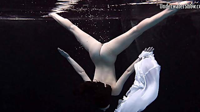 Andrejka slowly takes down her skirt while diving in the pool