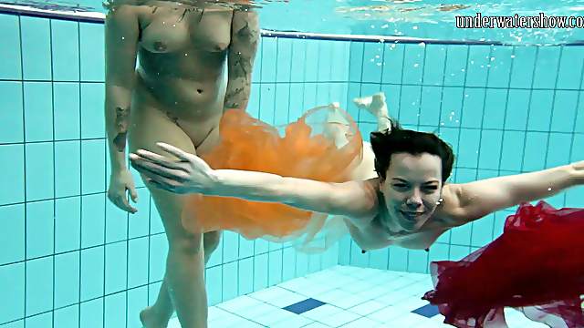 Two delicious babes fool around in the pool while being naked