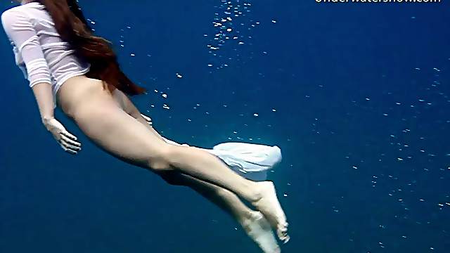 Raunchy brunette hottie removes her clothes while diving