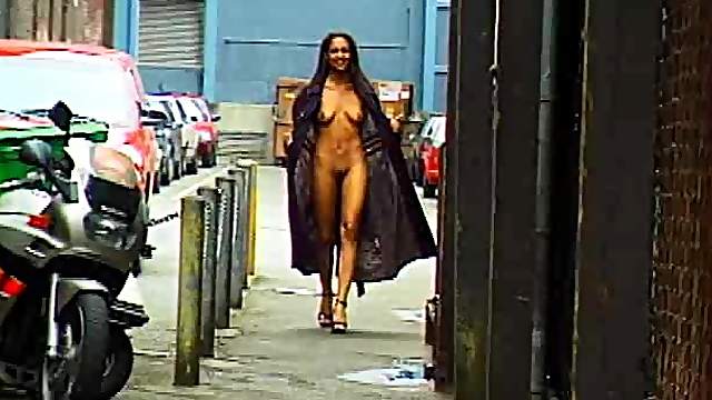 Good-looking ebony babe flashing her tits and pussy in public