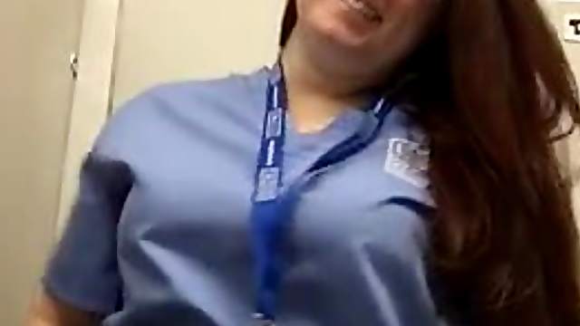 Nurse showing her pierced nipples