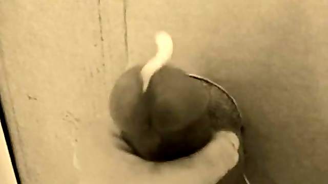 Jerking his big cock through our gloryhole