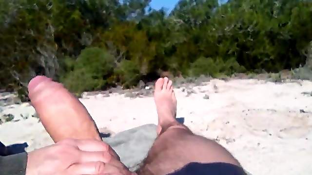 He's jerking off on the beach