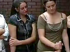 Luscious chicks give a handjob to a guy in POV video