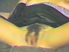 A retro MILF shows off her hairy snatch as she fingers