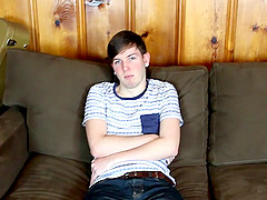 Tattooed gay guy with a hot body playing with his big cock on his couch
