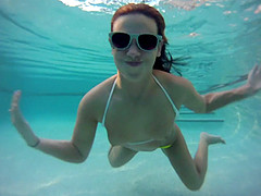 Immaculate solo model in a bikini goes for a swim in the pool