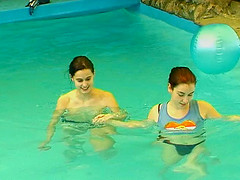 Salacious lesbians fondling in the pool before sharing a double ended dildo