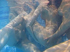 Icy hot lesbian babes get frisky in the pool in an enticing threesome