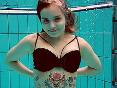 Hot inked honey strips out of her clothes inside of the pool