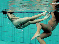 Two delicious hotties enjoy swimming in the pool while being naked