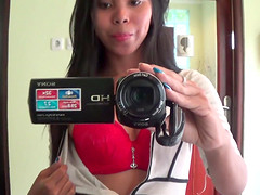 Sexy brunette Asian babe fools around with the camera
