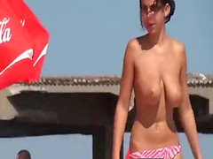 Young lady lying on the beach tried to become a tan