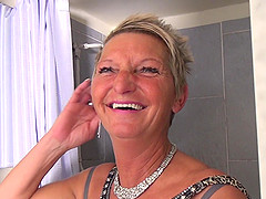 Short haired mature blonde amateur Karin M. plays with a dildo